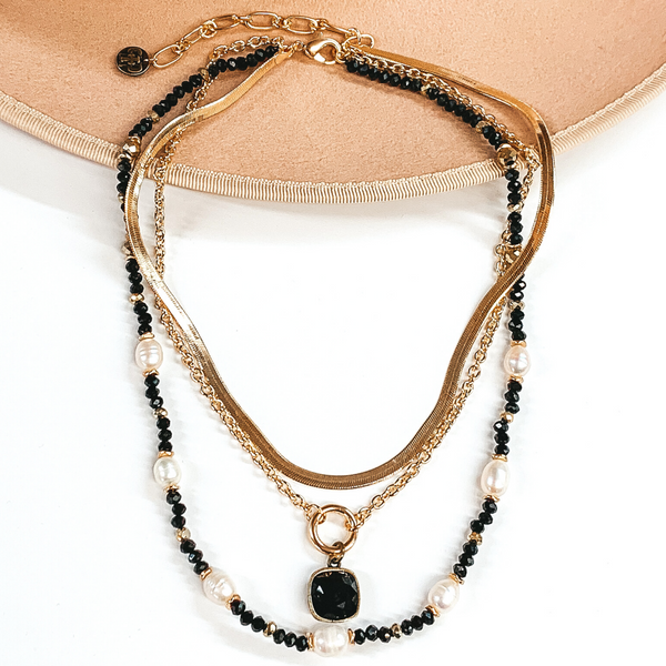 Pink Panache | 3 Strand Pearl and Black Beaded Necklace with Gold Chains and Black Cushion Cut Crystal Drop