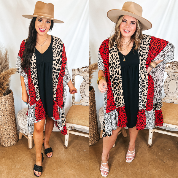 Models are wearing a mix print kimono that is red, ivory, and black. Both models have it on over a black dress with a tan hat.