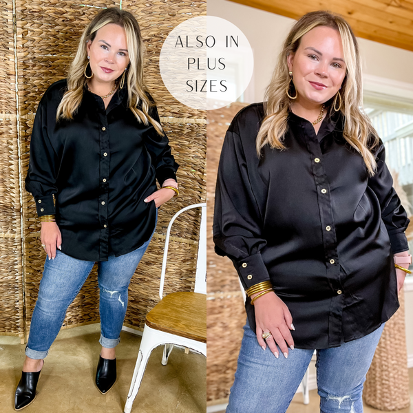 Model is wearing a black button up top with long sleeves and a collared neckline. Model has it paired with distressed skinny jeans, black mules, and gold jewelry.