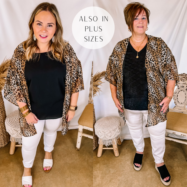 Models are wearing a leopard print kimono over a black top and white skinny jeans. Size large model has it paired white sandals and gold jewelry. Plus size model has it paired with black wedges and gold jewelry.