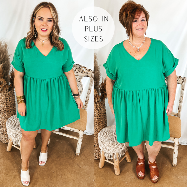 Models are wearing a green babydoll dress with a v neckline. Size large model has it paired with white heels and gold jewelry. Plus size model has it paired with brown wedges and silver jewelry.