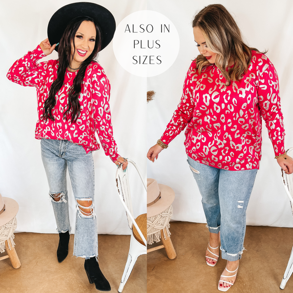 Models are wearing a long sleeve sweater that is hot pink with metallic leopard spots. Both models have it paired with light wash jeans. Size small model has it paired with a black hat and black boots. Size large model has it paired with white heels and silver jewelry.