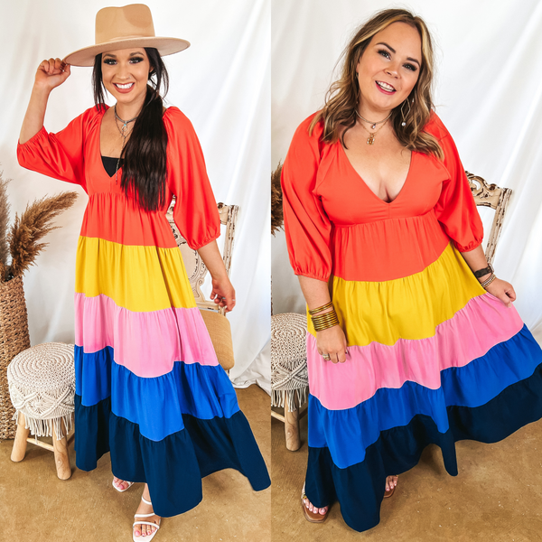 Models are wearing a coral, yellow, pink, blue, and navy maxi dress, Size small model has it paired with a tan hat, white heels, and silver jewelry. Size large model has it paired with gold sandals and gold jewelry.