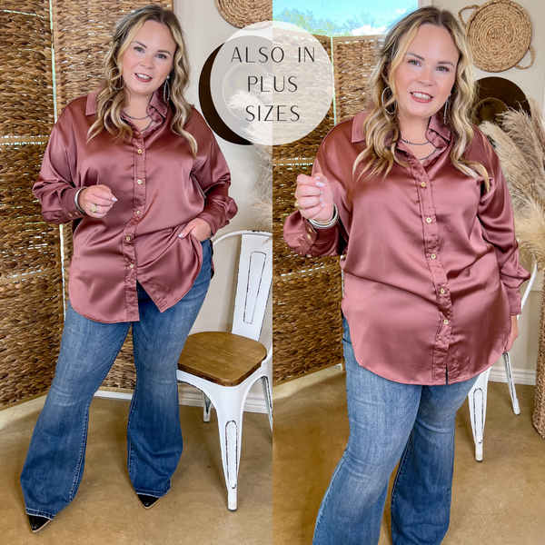 Model is wearing a long sleeve satin top with a button up front, long sleeves, and a collared neckline. Model has it paired with flare jeans, mules, and silver jewelry