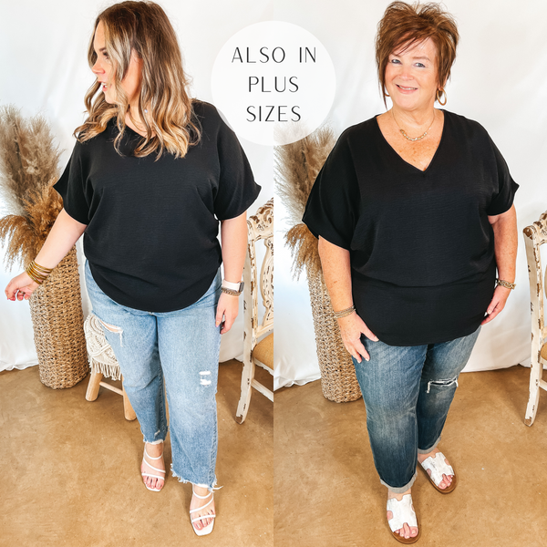 Models are wearing a solid black v neck top with short sleeves. Size large model has it paired with distressed boyfriend jeans, white heels, and gold jewelry. Plus size model has it paired with white sandals, distressed boyfriend jeans, and gold jewelry.