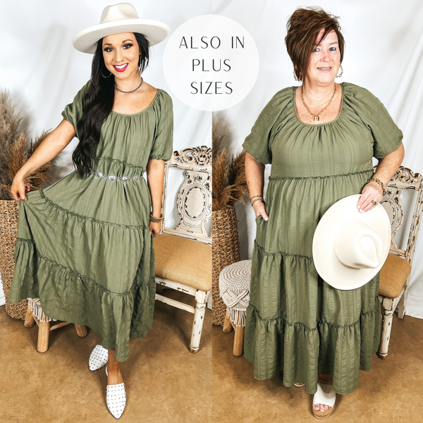Models are wearing an olive green ruffle tiered maxi dress. Size small model has it paired with white mules, a silver belt, and ivory hat. Plus size model has it paired with white sandals, an ivory hat, and gold jewelry.