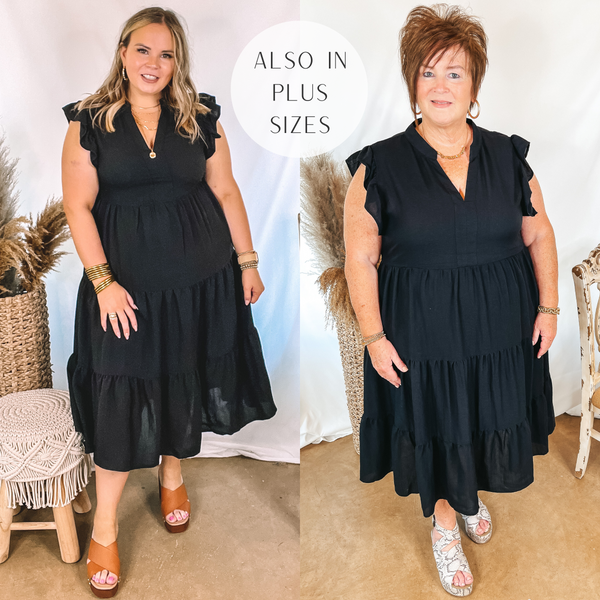 Models are wearing a black tiered midi dress that has ruffle cap sleeves. Size large model has it paired with tan wedges and gold jewelry. Plus size model has it paired with snakeskin wedges and gold jewelry.