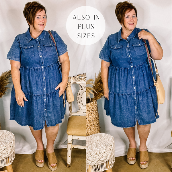 Model is wearing a button up dark wash denim dress with a button up front and collared neckline. Model has it paired with tan wedges and a tan purse.