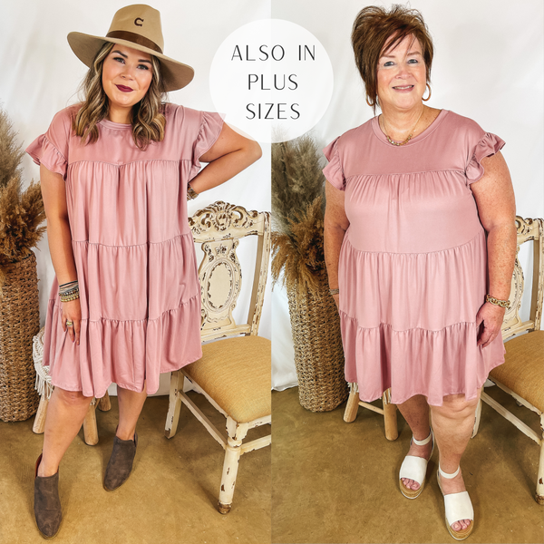 Models are wearing a dusty pink ruffle tiered mini dress. Size large model has it paired with a tan hat and brown booties. Plus size model has it paired with white sandals and gold jewelry.
