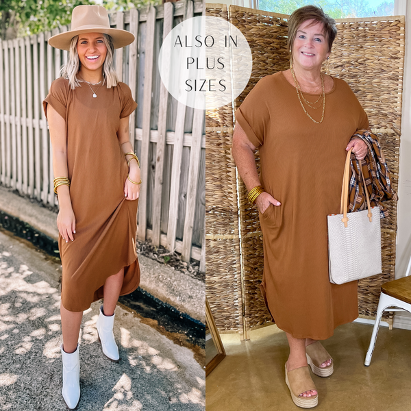 Model is wearing a short sleeve ribbed midi dress in light brown. Model has it paired with white booties, a tan hat, and gold jewelry.