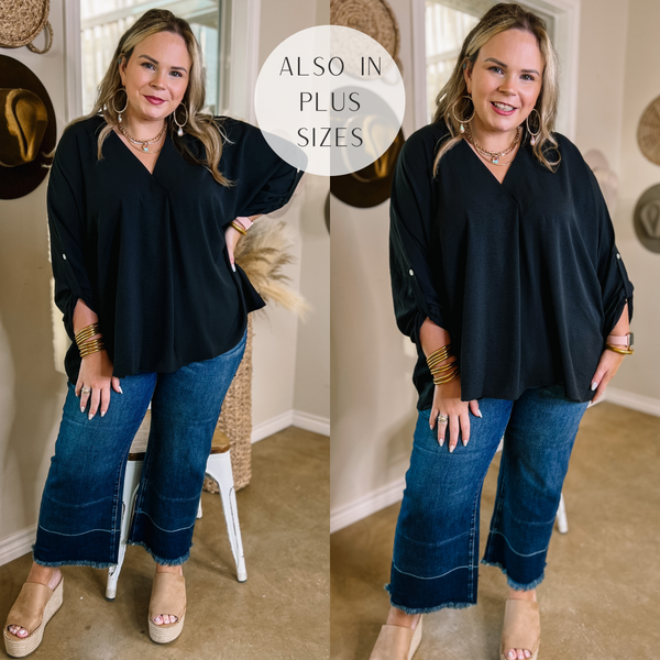 Model is wearing a black 3/4 sleeve top with a placket, and a flowy fit. Model has it paired with cropped denim jeans, tan wedges, and gold jewelry.