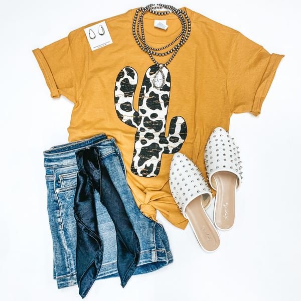 Steady as the Saguaros Cow Print Cactus Short Sleeve Graphic Tee in Mustard