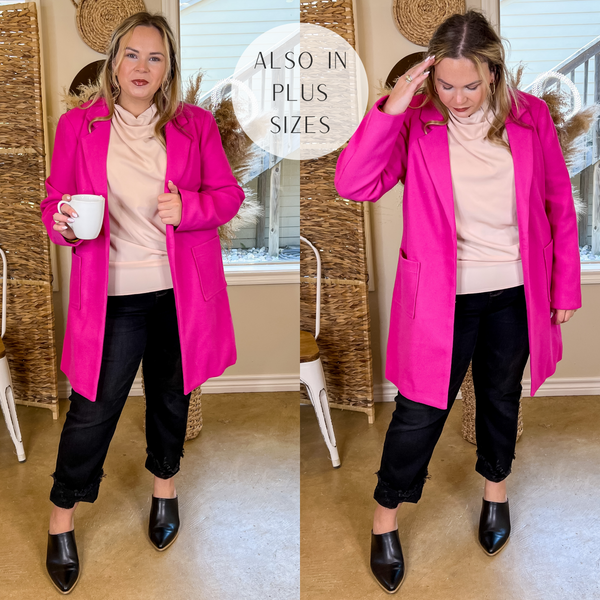 Model is wearing an open front long hot pink coat. Model has this collared coat paired with a beige top, black jeans, black mules, and gold jewelry.