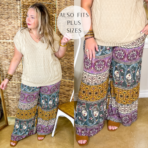 Model is wearing a pair of green mix print pants with an elastic waist. Model has it paired with a beige sweater, tan sandals, and gold jewelry.