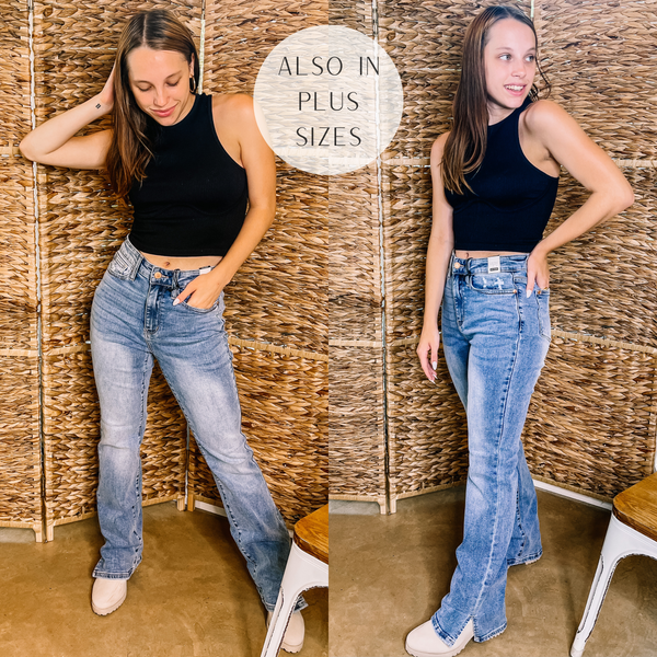 Model is wearing a pair of light wash bootcut jeans with a small slit at the ankle. Model has these jeans paired to a black tank top, tan booties, and gold jewelry.