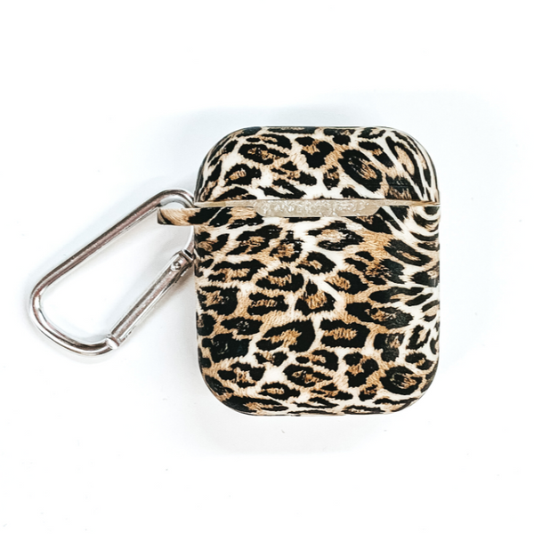 This is a leopard print airpod case with a silver clip. This airpod case is pictured on a white background.